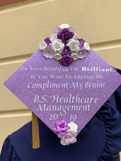 a purple graduation cap with flowers on it that reads, complimentent my brain b s healthcare management