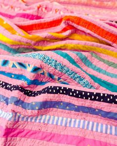 colorful quilts are laying on top of each other