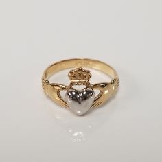 "Thanks for shopping our vintage estate store. We tend to sell well below wholesale and truly hope you enjoy all of our items. Many of the items are one of a kind, so please enjoy scrolling through the pictures and hopefully something will catch your eye. Blacks spots are from camera or reflections. Beautiful estate 14k gold yellow white gold Irish Claddagh infant or baby ring. Retails $299 on sale $149 Ring size: 1 Setting: 3/8\" 8.5mm Band width: 2mm Weight: .1.07 grams Beautiful ring, one tha Classic 14k White Gold Heart Ring, Heirloom Engraved Heart Ring, Heirloom 14k Gold Heart-shaped Rings, Antique Yellow Gold Heart Cut Jewelry, Classic Heart Ring For Promise Occasion, Antique 14k Gold Jewelry With Hallmark, Vintage Engraved Heart Ring For Wedding, Heirloom Heart Promise Ring, Classic Engraved Wedding Ring With Hallmark