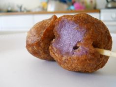 two donuts with toothpicks sticking out of them sitting on a counter top