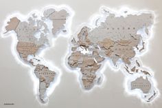 a map of the world made out of cut up pieces of paper with lights around it