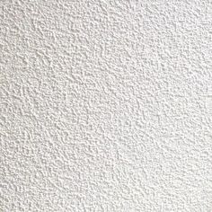 a white wall that has some kind of textured paint on it, and is very close to the ceiling