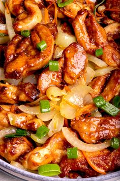 chicken and onions stir fry in a pan