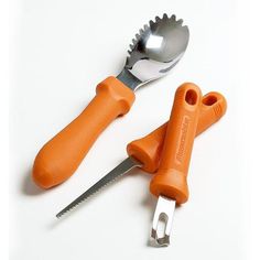 two orange handled utensils and a fork