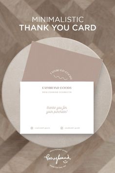 a white plate with a pink envelope on it and the words, minimalistic thank you card