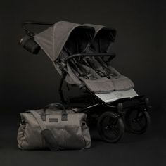 a baby stroller and diaper bag sitting next to each other on a black background