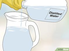 a pitcher filled with water next to a glass jug that says distilled water