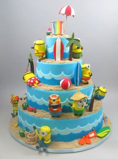 a three tiered cake decorated with spongebob characters and umbrellas on the beach