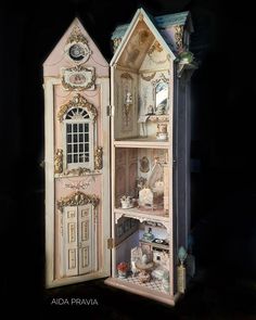 the doll house is made out of wood and has an open door to it's outside