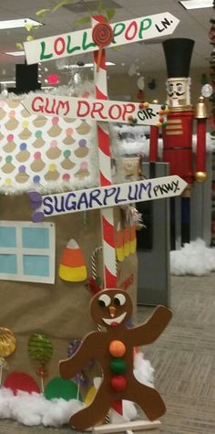 an office cubicle decorated with candy canes, gum drop and a gingerbread man