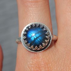 The Doria Ring features a stunning labradorite that glows blue like Dory from Finding Nemo! The intricate sterling silver setting paired with this unique stone make it a future heirloom! I hope you enjoy this piece for many years to come! Details: Size 10 (can be sized up to 11. Just let me know with a note at checkout! Intricate sterling silver setting with gorgeous floral band High quality round labradorite This item will be shipped within 5 business days. Each piece is handmade by me in my studio by the beach in beautiful Marina Del Rey, CA. Care Instructions: This handmade piece should be treated with care to ensure its longevity. You may choose to remove it when washing hands, bathing, swimming, applying lotion, etc. Please store in an airtight bag or anti-tarnish pouch away from mois Sterling Silver Round Moonstone Fusion Ring, Silver Sterling Moonstone Ring In Fusion Style, Fusion Style Silver Moonstone Ring In Sterling Silver, Unique Moonstone Ring In Sterling Silver With Bezel Setting, Silver Labradorite Rings For Anniversary, Unique Sterling Silver Moonstone Ring With Bezel Setting, Round Labradorite Moonstone Ring Stamped 925, Silver Labradorite Jewelry For Wedding, Celestial Silver Labradorite Jewelry