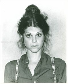 an old black and white photo of a young woman with her hair in buns