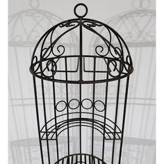 a metal birdcage sitting on top of a table