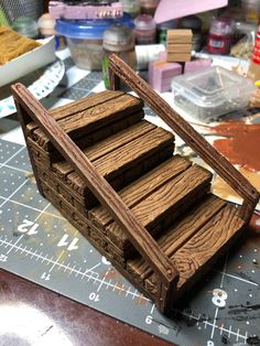 a wooden box sitting on top of a table next to other crafting supplies and tools