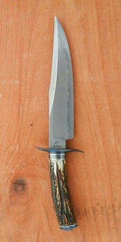 a large knife on top of a wooden table