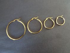 This listing is for a pair of vacuum plated Stainless Steel gold hoop earrings. Each hoop earring is made of vacuum plated Stainless Steel in a circle shape. The earrings feature a classic minimalist style in 4 size options!  Jewelry Type- Earrings Jewelry Sub-Type- Metal Earrings, Hoop Earrings Style- Minimalist, Simple, Classic Hypoallergenic- Yes 20MM about 0.79 inch(20mm) in diameter, 0.08 inch(2mm) thick / Pin- 0.02 inch(0.6mm) 25MM about 0.98 inch(25mm) in diameter, 0.08 inch(2mm) thick / Round Earrings Circles Gold, Classic Minimalist Style, Golden Hoops, Hoop Earrings Style, Gold Pin, Stainless Steel Pendant, Style Minimalist, Special Jewelry, Metal Earrings