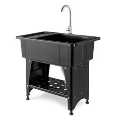 a black sink sitting on top of a wooden stand