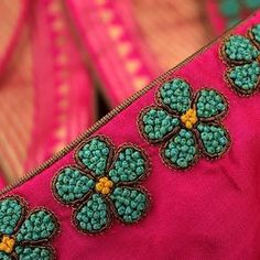 a pink purse with green flowers on it