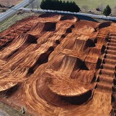 an aerial view of a skate park being built on the side of a road with ramps