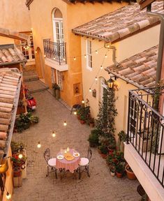 an aerial view of a courtyard with tables and chairs