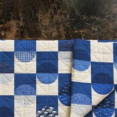 two blue and white quilts on top of each other