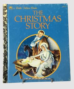 the christmas story book with an image of jesus and baby jesus on it's lap