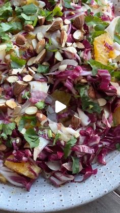 a white plate topped with salad and nuts