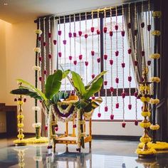 a decorated room with flowers and garlands on the windowsill