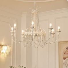 a chandelier hanging from the ceiling in a room