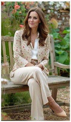 a woman sitting on top of a wooden bench