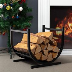 a stack of logs sitting in front of a christmas tree