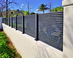 a white fence with black slats on it