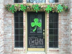 the front door is decorated with green shamrocks for st patrick's day celebrations