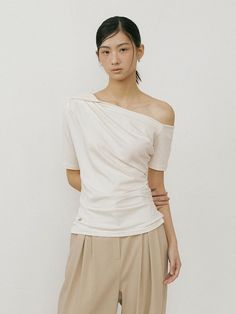 This is a minimal and feminine top by Lucirzu that is made out of high quality and sturdy material. With distinctive mood of the design and comfortable wear, you can use it for your daily lifestyle.- Natural drape and feminine look- Shirring detail on the waistline- Modern and minimal mood Chic Solid Color Tops With Relaxed Fit, Modern Asymmetrical Solid Color Tops, White Fitted Effortless Style Tops, Effortless White Fitted Tops, White Fitted Effortless Tops, Fitted White Effortless Tops, Effortless Fitted White Tops, Asymmetrical Cotton Top With Relaxed Fit, Chic Tops For Layering With Relaxed Fit