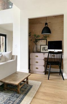 a living room filled with furniture and a flat screen tv sitting on top of a wooden table