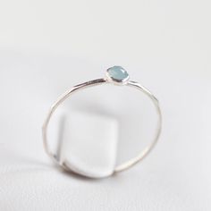 Tiny skinny stackable ring with beautiful Aquamarine stone. The ring is 0,8-0,9 mm thick and looks very dainty on the finger. Choose the size and cut of the stone (3 or 5 mm smooth cabochons or rose cut) and material for the ring (sterling silver or 9k gold). I have milky blue stones and transparent blue stones (see the pictures). If you want to change the ring band design or get a custom ring or ring sets, feel free to contact me. You can order a ring of any size. There is a personalization fie Minimalist Faceted Stackable Rings, Dainty Sterling Silver Stackable Rings With Bezel Setting, Minimalist Everyday Topaz Ring, Simple Sterling Silver Stackable Birthstone Rings, Dainty Stackable Sterling Silver Crystal Ring, Delicate Sterling Silver Stackable Birthstone Ring, Minimalist Stackable Sapphire Ring In Sterling Silver, Band Design, Blue Stones