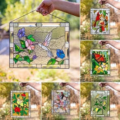 several different stained glass pictures hanging on a string in front of some trees and bushes