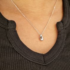 Our Silver Drop Charm Necklace features a thick silver water drop charm. This dainty necklace looks great layered with other minimalist necklaces or worn alone. We make our jewellery in small batches to reduce wastage. Our jewellery is designed with the modern Woman in mind, elegant, unique pieces with a classic touch. Our jewellery is great for gifting, whether it's Valentines, Mothers Day, Birthday or simply a gift for a friend, sister etc. Material- 925 Sterling Silver Length- 40 + 5cm Pendan Delicate White Gold Teardrop Pendant Necklace, Delicate Teardrop Charm Necklaces For Everyday, Everyday Teardrop Charm Necklace With Delicate Chain, Everyday Delicate Teardrop Charm Necklace, Minimalist Water Drop Jewelry For Gifts, Minimalist Water Drop Jewelry As Gift, Minimalist Water Drop Jewelry Gift, Everyday Teardrop Sterling Silver Charm Necklaces, Everyday Sterling Silver Teardrop Charm Necklaces