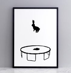 a black and white poster with a rabbit sitting on it's back in front of a coffee table