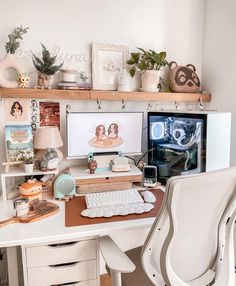 a white desk topped with a computer monitor and keyboard