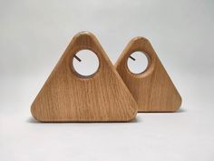 two wooden clocks with holes in the middle