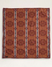 an orange and grey patterned cloth hanging on a wall