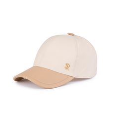 a white baseball cap with a gold logo on the front and tan brimmed visor