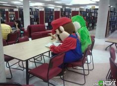 a person sitting at a table in a library