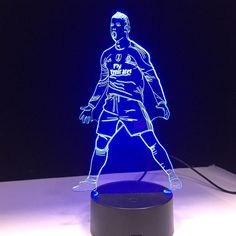 a 3d image of a soccer player is shown on a table top with a blue light