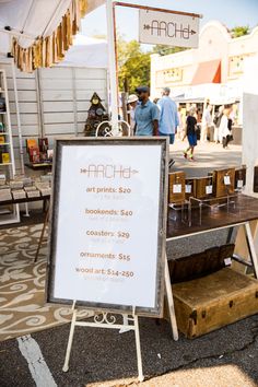 a sign advertising art prints at an outdoor market