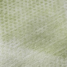 an area rug with green and white dots on it