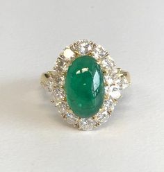 18K Yellow Gold Emerald & Diamond Cocktail Ring Description18K Yellow Gold Ring; 1 Oval Cabochon Cut Emerald 4.00 Carat; 6 Marquis Cut/10 Round Brilliant Cut Diamonds 1.50 Carat Total Weight, Clarity SI-2, Color H-I; Finger Size 6 3/4; 8.6 Grams. Payment All payments must be made through PayPal, NO EXCEPTIONS. We cannot accept payment plans. We do not offer Layaway. Shipping We ship via USPS Registered Mail, Return Receipt in order to provide tracking and insured delivery, which usually takes 5-7 days ($25) **OVERNIGHT SHIPPING available upon request ($40); please request overnight shipping upon your winning bid!! Expedited shipping fee will be added to your total AND expedited shipping service will be arranged for you.  We ship within one business day (holidays and weekends we do not ship