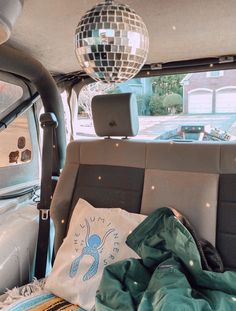 there is a disco ball hanging from the ceiling in the back of a car,