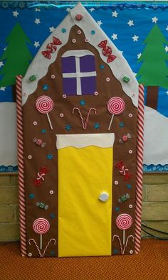 a gingerbread house made to look like it has candy on the door